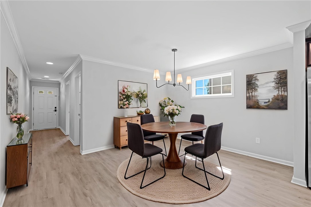 1237 Madden Bridge Road Central, SC 29630 - Photo 11 of 46 This bright dining area features an elegant chandelier and beautiful flooring, perfect for gatherings.