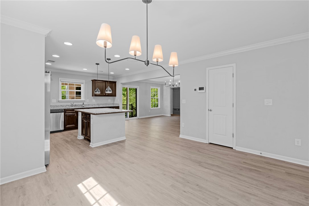 1237 Madden Bridge Road Central, SC 29630 - Photo 12 of 46 This open concept space features a kitchen island and bright windows, creating an inviting atmosphere.
