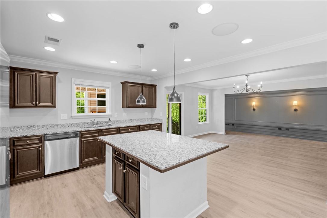 1237 Madden Bridge Road Central, SC 29630 - Photo 13 of 46 This spacious kitchen, featuring a central island, flows seamlessly into the adjacent living area.