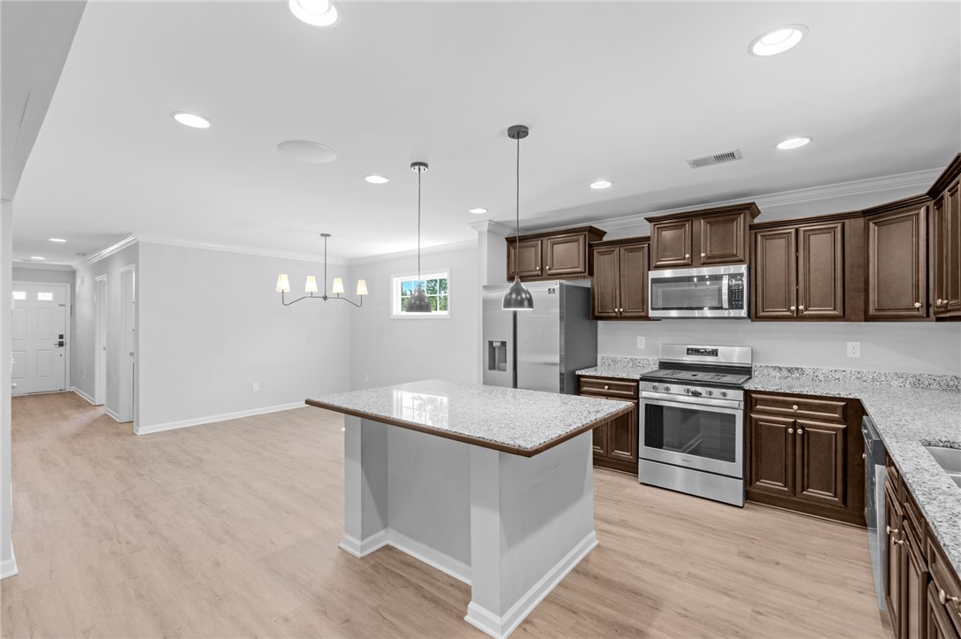 1237 Madden Bridge Road Central, SC 29630 - Photo 16 of 46 This bright kitchen features modern appliances and an inviting island, perfect for entertaining.