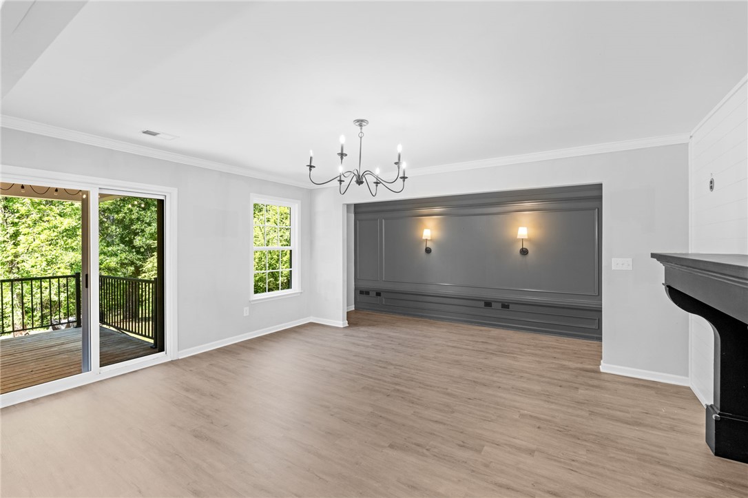 1237 Madden Bridge Road Central, SC 29630 - Photo 19 of 46 This bright living space features wood flooring, a fireplace, and a balcony with expansive outdoor views.