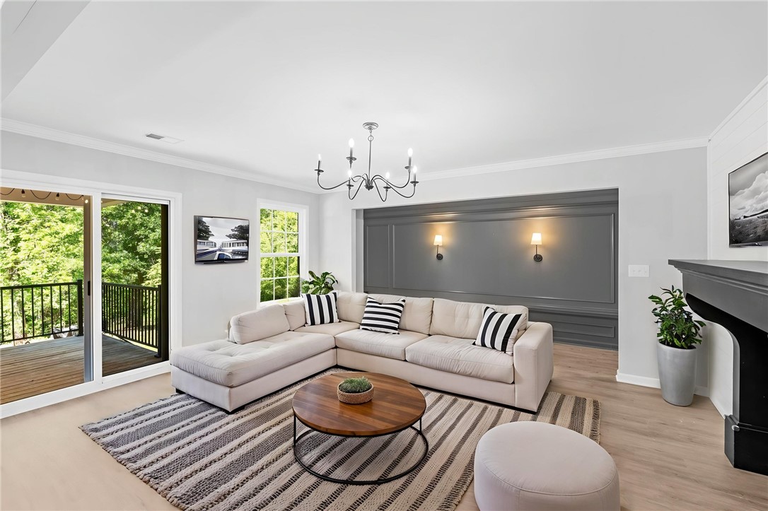 1237 Madden Bridge Road Central, SC 29630 - Photo 20 of 46 This bright living space features elegant crown molding and a charming fireplace, perfect for relaxing evenings.