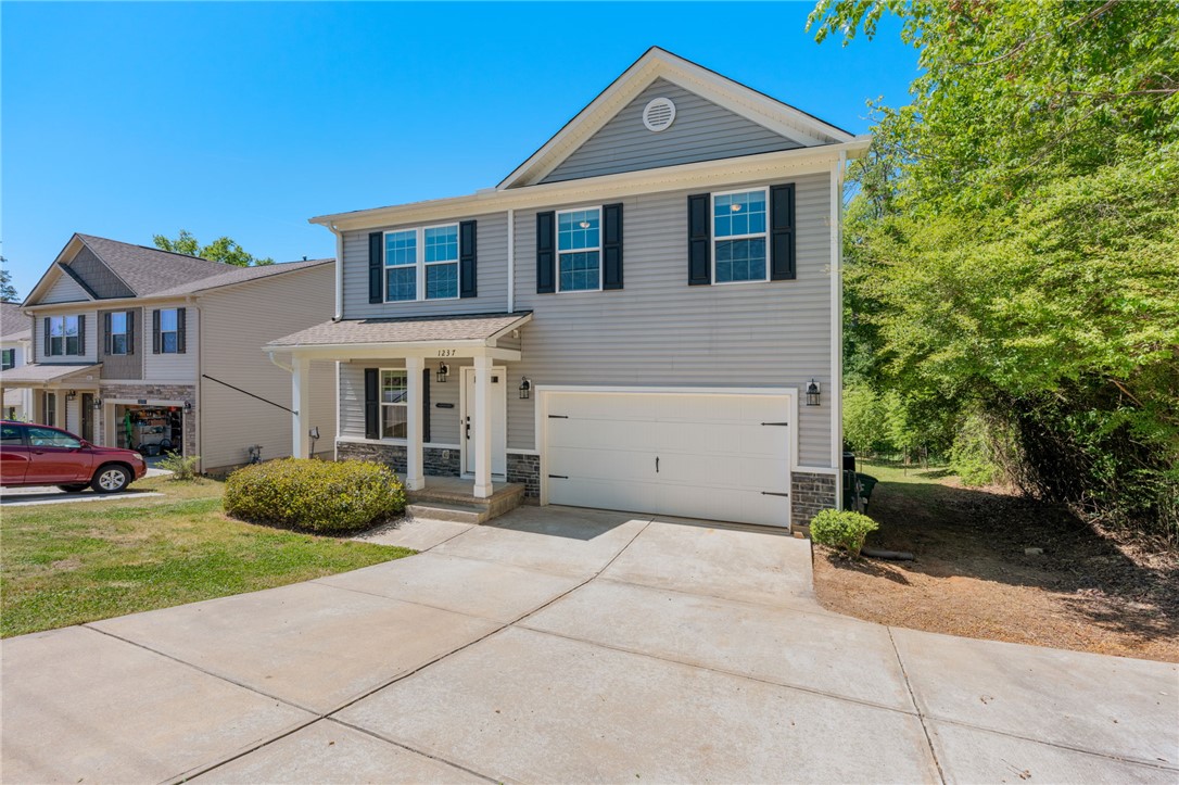 1237 Madden Bridge Road Central, SC 29630 - Photo 2 of 46 This charming home offers curb appeal with classic siding and a welcoming porch.