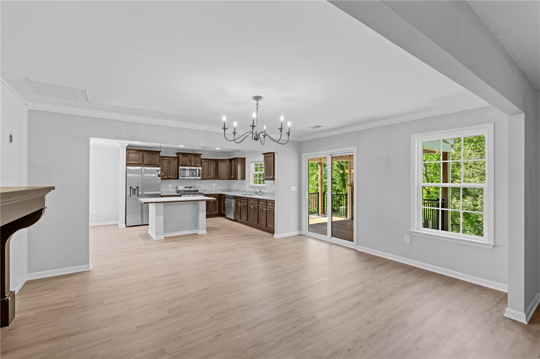 1237 Madden Bridge Road Central, SC 29630 - Photo 21 of 46 This expansive open-concept living area seamlessly connects to a modern kitchen and inviting outdoor space.