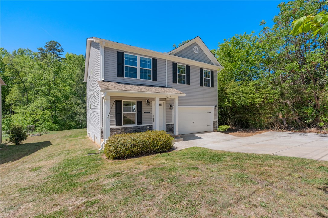 1237 Madden Bridge Road Central, SC 29630 - Photo 3 of 46 This two-story home with a garage offers comfortable living and convenient access.