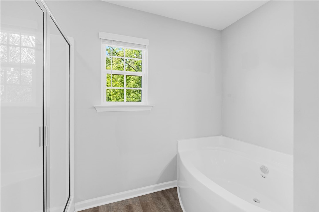 1237 Madden Bridge Road Central, SC 29630 - Photo 33 of 46 This serene bathroom offers a bright window and a relaxing soaking tub for peaceful moments.