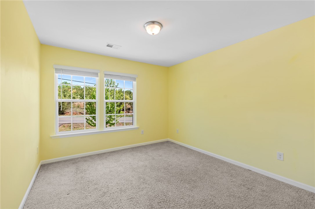 1237 Madden Bridge Road Central, SC 29630 - Photo 34 of 46 This bright room features carpet flooring and ample natural light through its windows.