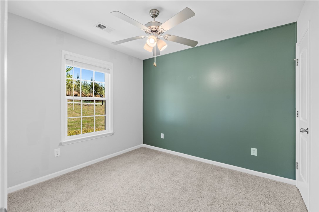 1237 Madden Bridge Road Central, SC 29630 - Photo 7 of 46 This cozy bedroom offers carpet flooring and a refreshing view from the window.