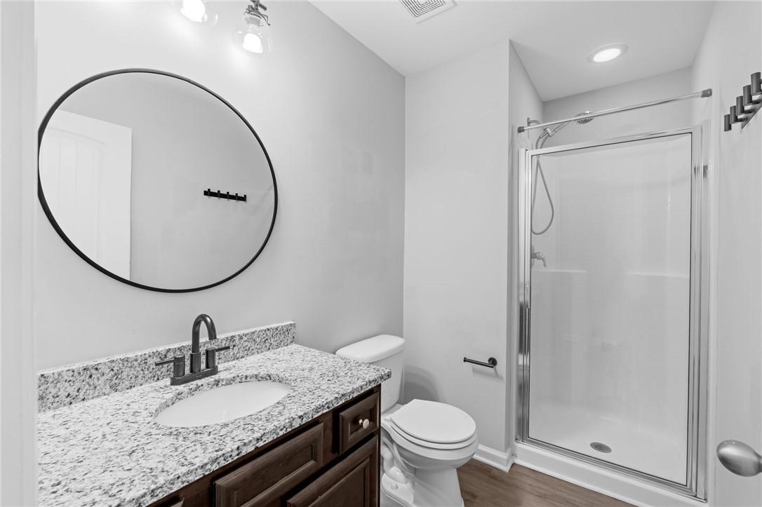 1237 Madden Bridge Road Central, SC 29630 - Photo 8 of 46 This sleek bathroom features a modern vanity and a clear glass shower, optimizing both form and function.