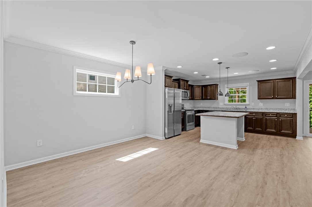 1237 Madden Bridge Road Central, SC 29630 - Photo 9 of 46 This inviting space seamlessly combines a bright dining area with a functional kitchen, perfect for everyday living.