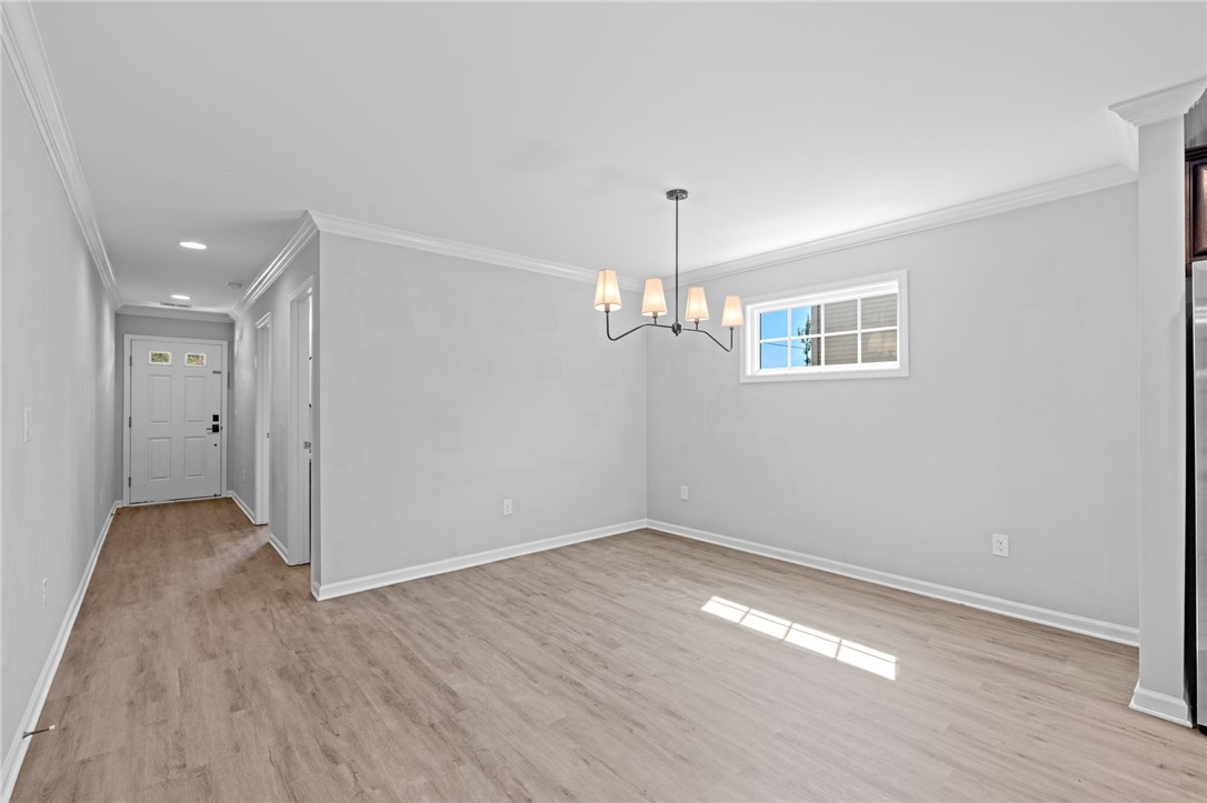1237 Madden Bridge Road Central, SC 29630 - Photo 10 of 46 This bright interior features modern finishes, a stylish chandelier, and ample natural light through a window.