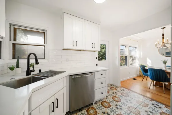a kitchen with stainless steel appliances a sink and a refrigerator