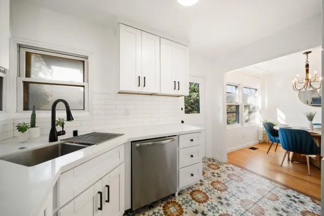 a kitchen with stainless steel appliances a sink and a refrigerator