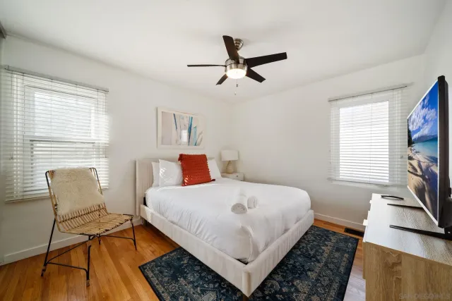 a bedroom with a bed a rug and a window