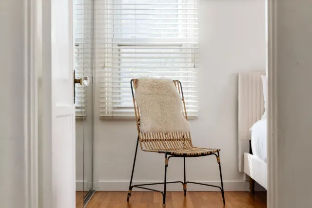 a view of a hallway with wooden floor and a potted plant