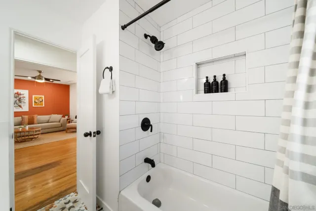 a bathroom with a bathtub and shower