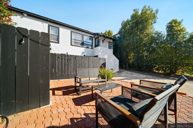 a view of a backyard with sitting area