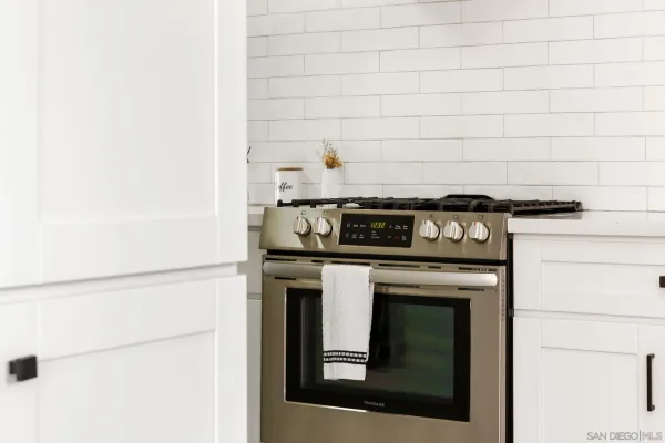 a stove top oven sitting inside of a kitchen