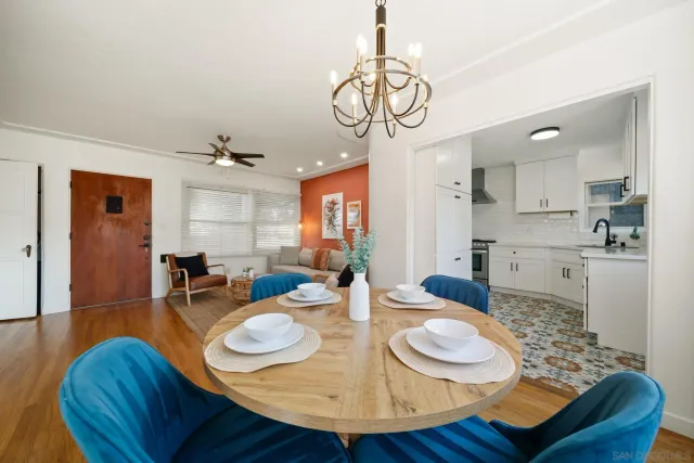 a view of a dining room with furniture wooden floor and chandelier