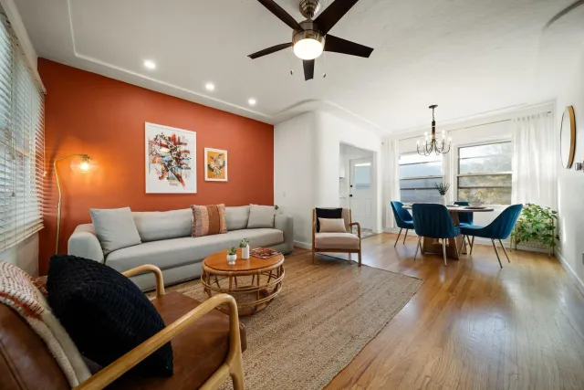 a living room with furniture and wooden floor