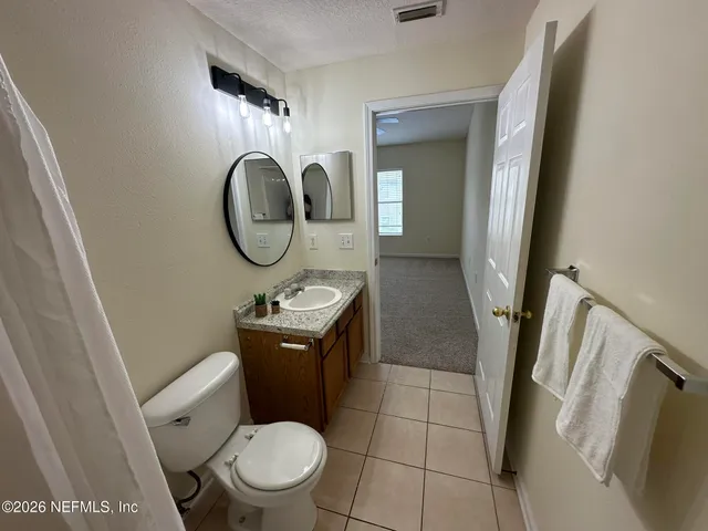 a bathroom with a toilet and a vanity