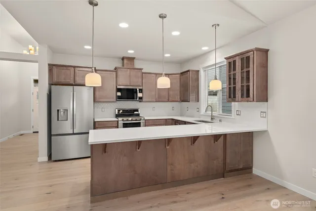 a large kitchen with stainless steel appliances kitchen island a large island in the center