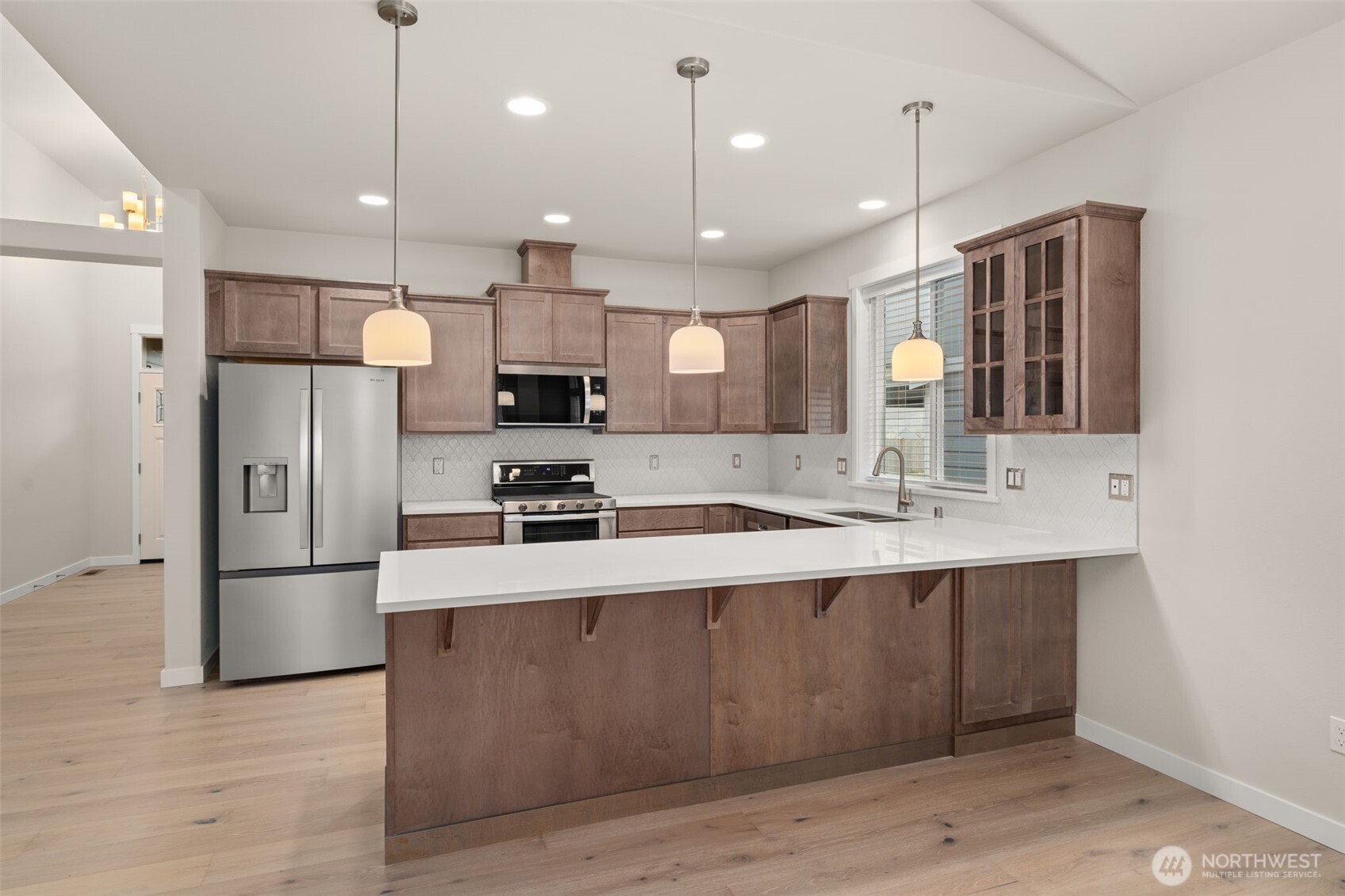 719 Maggee Street Southeast Lacey, WA 98513 - Photo 12 of 40 a large kitchen with stainless steel appliances kitchen island a large island in the center