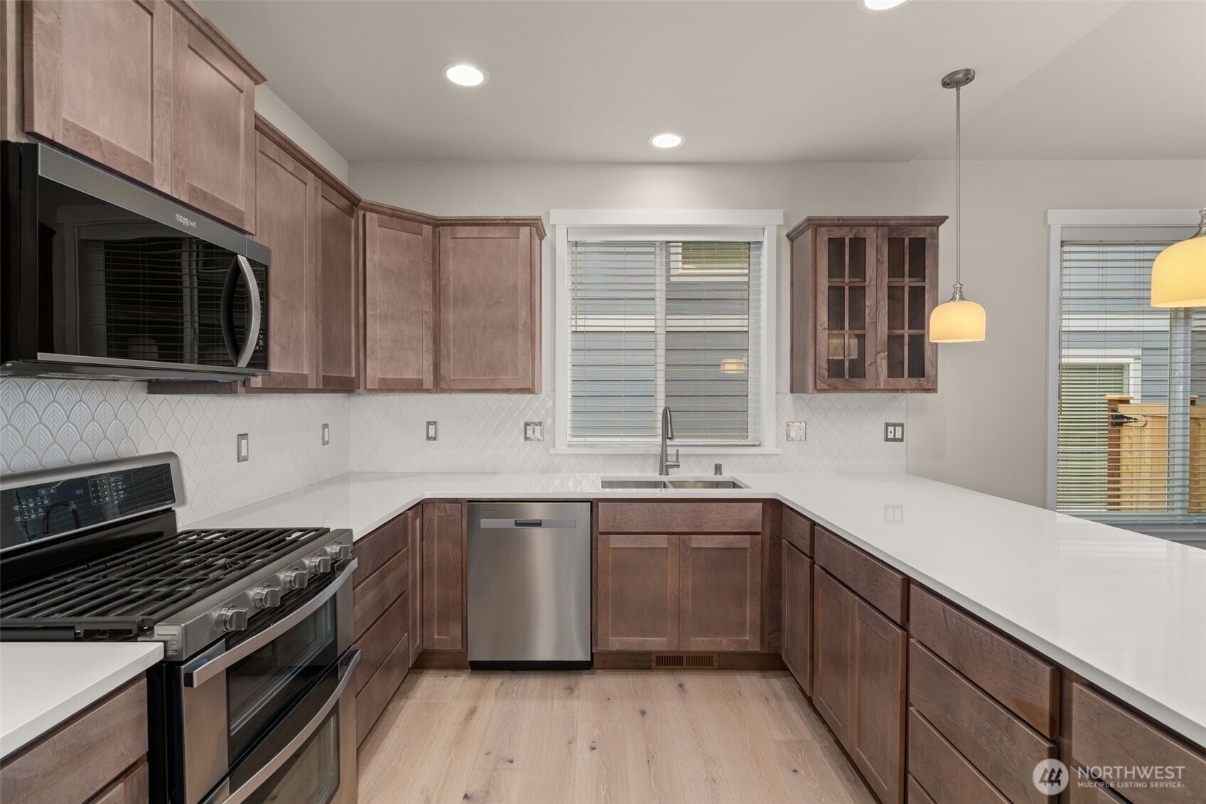 719 Maggee Street Southeast Lacey, WA 98513 - Photo 13 of 40 a kitchen with stainless steel appliances a sink stove and cabinets