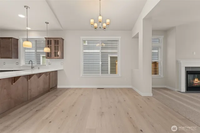 a spacious bathroom with a granite countertop sink a large mirror and a window