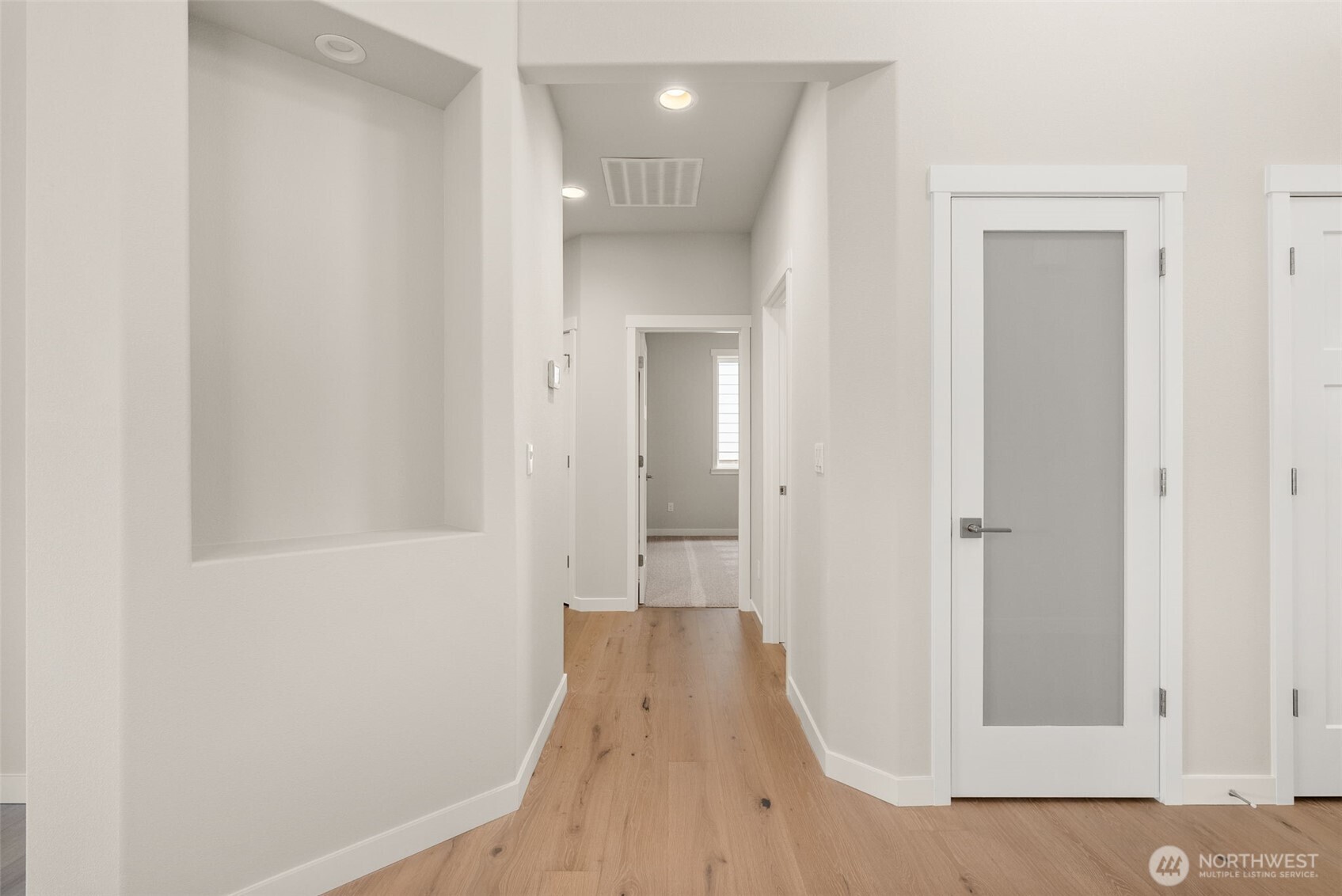 719 Maggee Street Southeast Lacey, WA 98513 - Photo 19 of 40 a view of a hallway with wooden floor and a bathroom