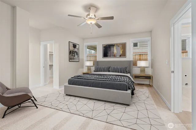 a bedroom with a large bed a rug and ceiling fan