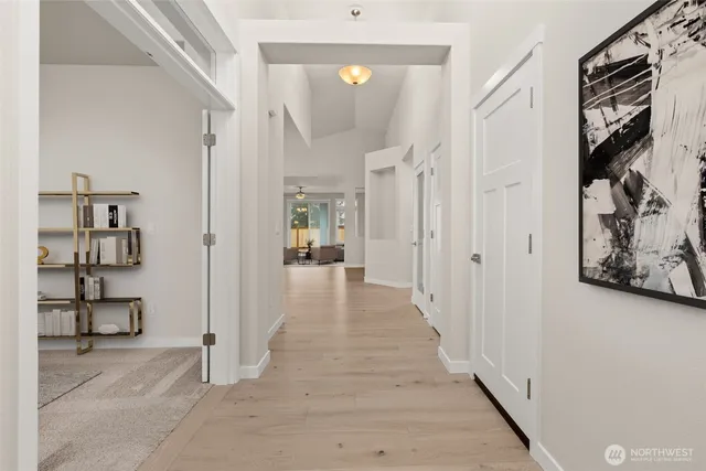 a view of a hallway with wooden floor and entryway