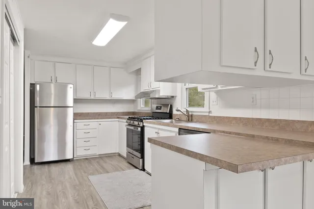 a kitchen with appliances cabinets and a sink
