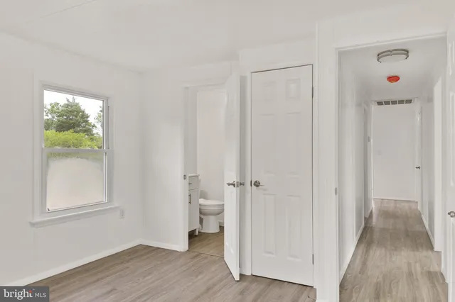 a view of a room with wooden floor and windows