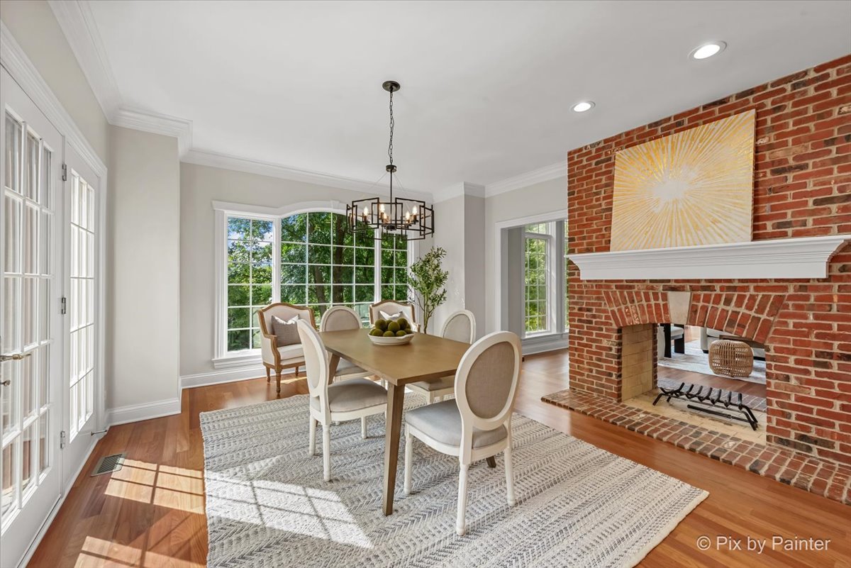 39W599 Walt Whitman Road St. Charles, IL 60175 - Photo 16 of 74 a dining room with furniture a chandelier and wooden floor