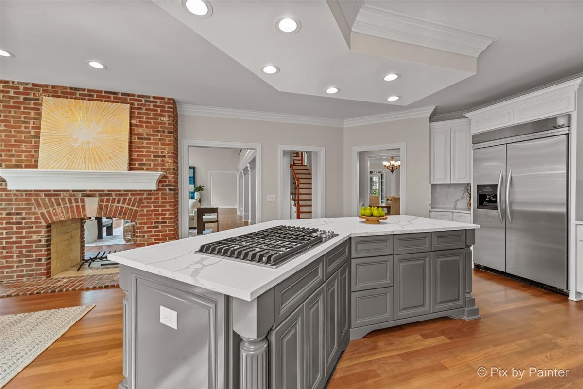39W599 Walt Whitman Road St. Charles, IL 60175 - Photo 20 of 74 a kitchen that has a lot of cabinets in it and wooden floor