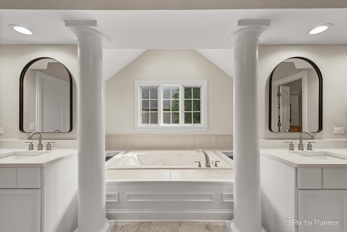 39W599 Walt Whitman Road St. Charles, IL 60175 - Photo 28 of 74 a bathroom with a double vanity sink and a mirror