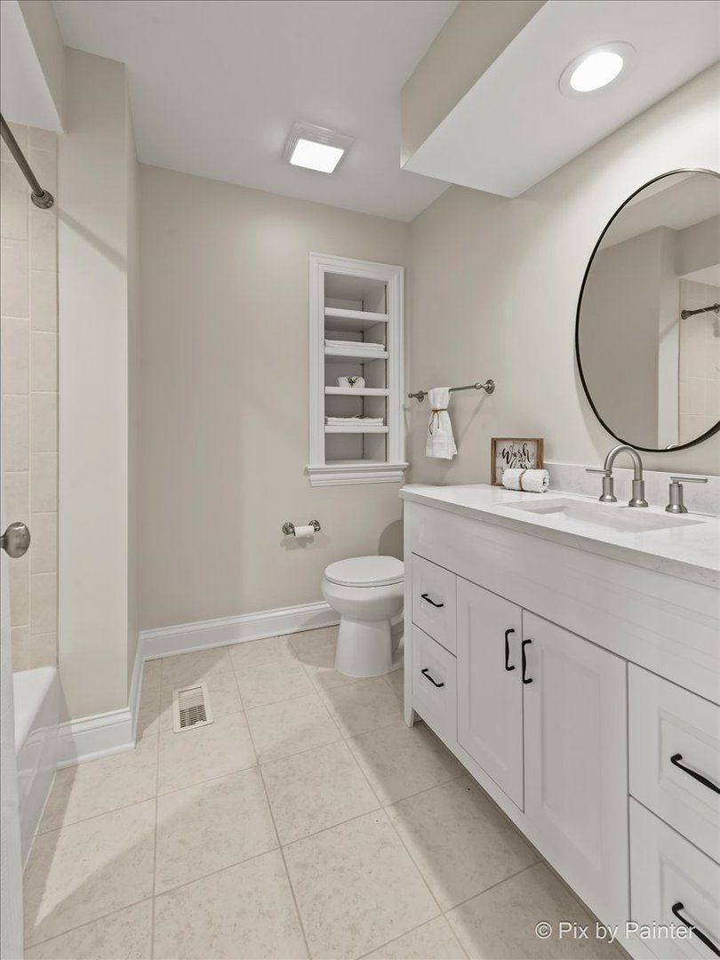 39W599 Walt Whitman Road St. Charles, IL 60175 - Photo 31 of 74 a spacious bathroom with a double vanity sink a toilet and a mirror