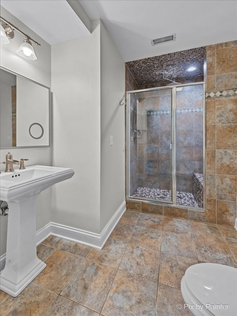 39W599 Walt Whitman Road St. Charles, IL 60175 - Photo 46 of 74 a bathroom with a sink a toilet and shower