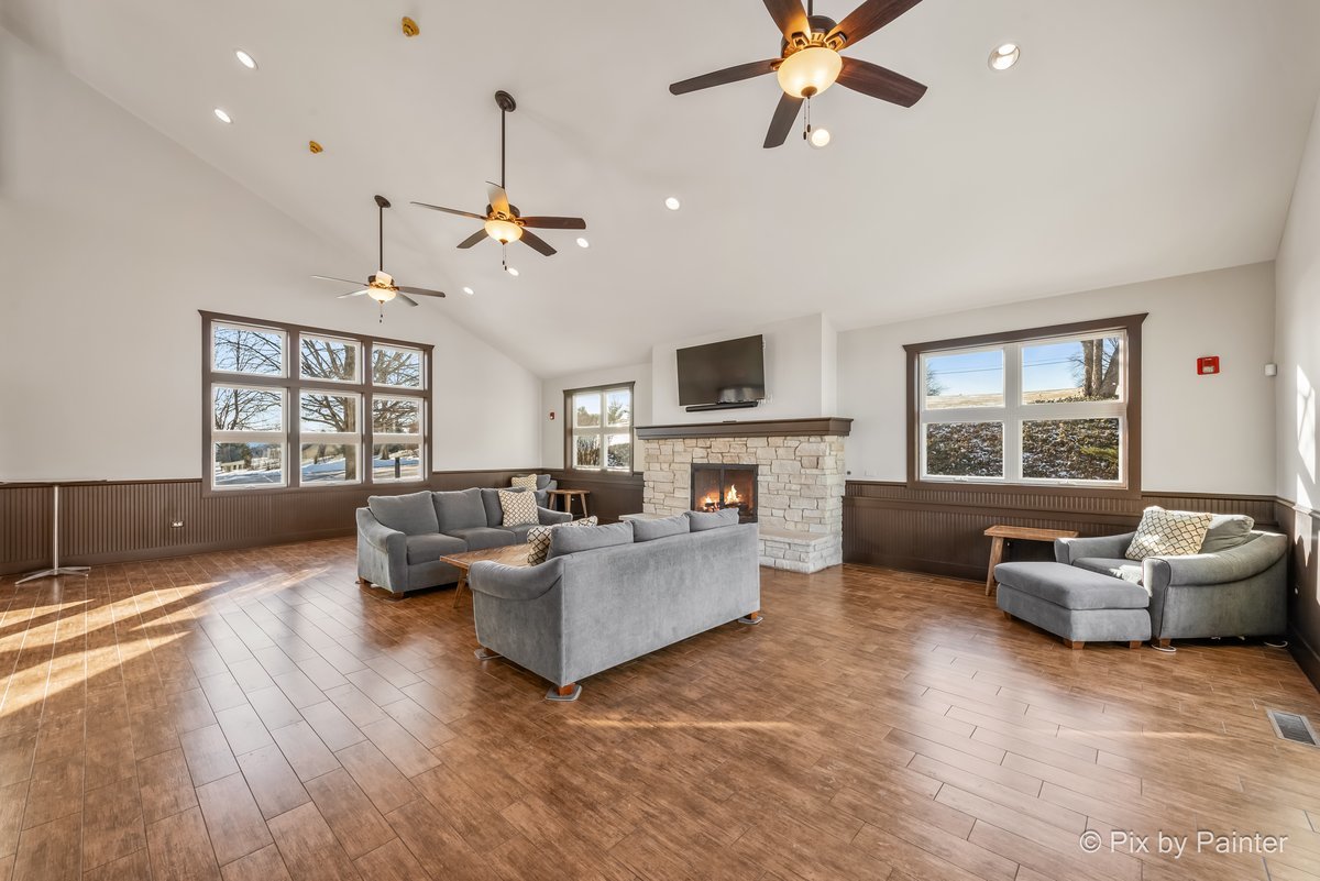 39W599 Walt Whitman Road St. Charles, IL 60175 - Photo 50 of 74 a living room with furniture or couches and a fireplace