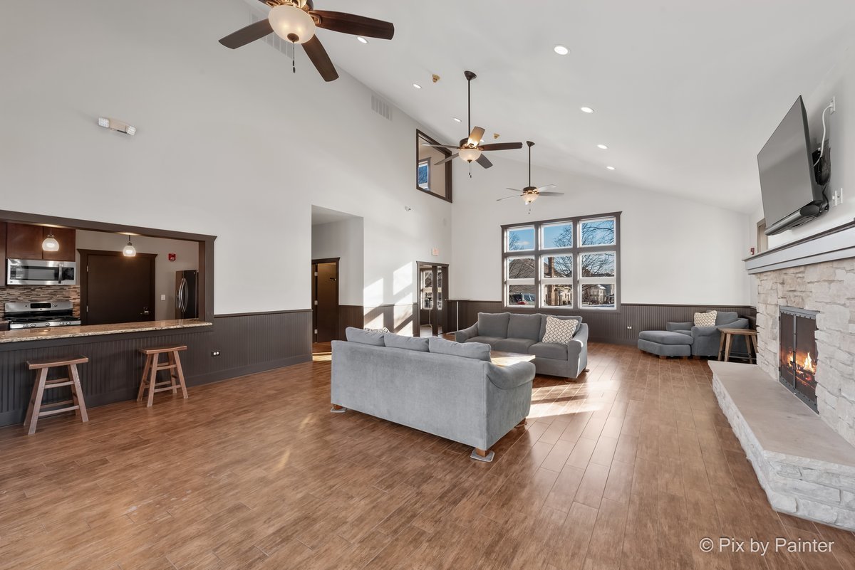 39W599 Walt Whitman Road St. Charles, IL 60175 - Photo 51 of 74 a living room with furniture a flat screen tv and kitchen view
