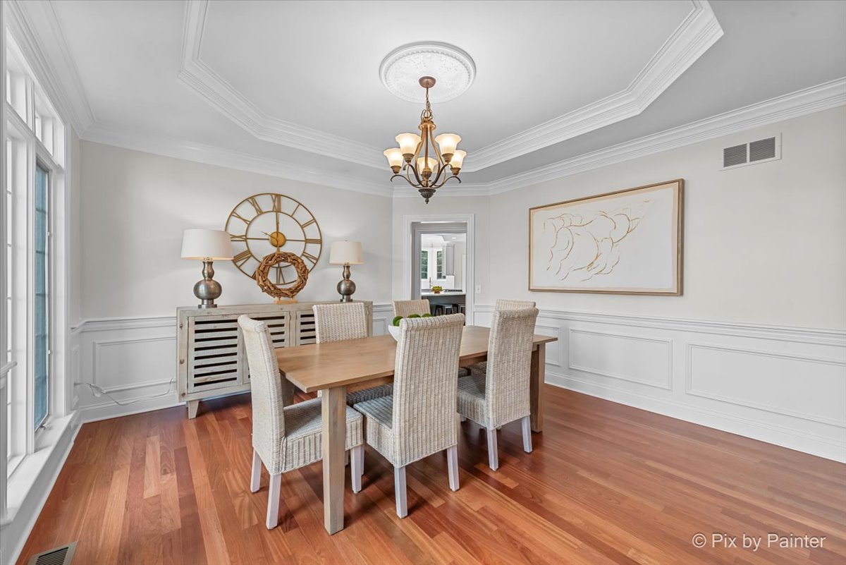39W599 Walt Whitman Road St. Charles, IL 60175 - Photo 7 of 74 a view of a dining room with furniture wooden floor and a chandelier