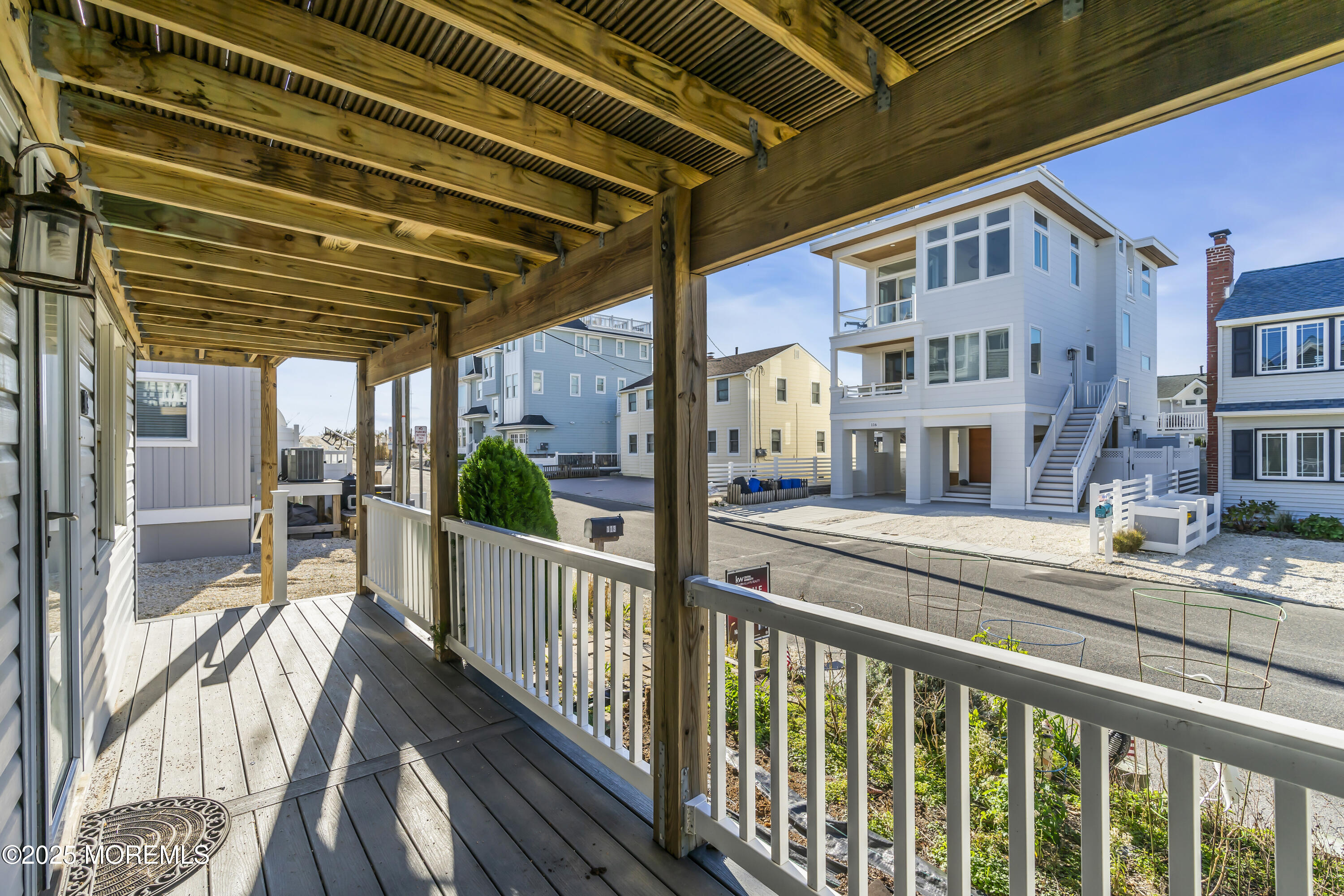 113 East Mermaid Lane Beach Haven, NJ 08008 - Photo 12 of 34 a view of a porch with a floor to ceiling window and wooden floor