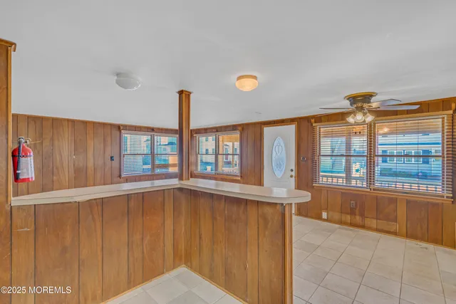 a view of empty room with a ceiling fan and a window
