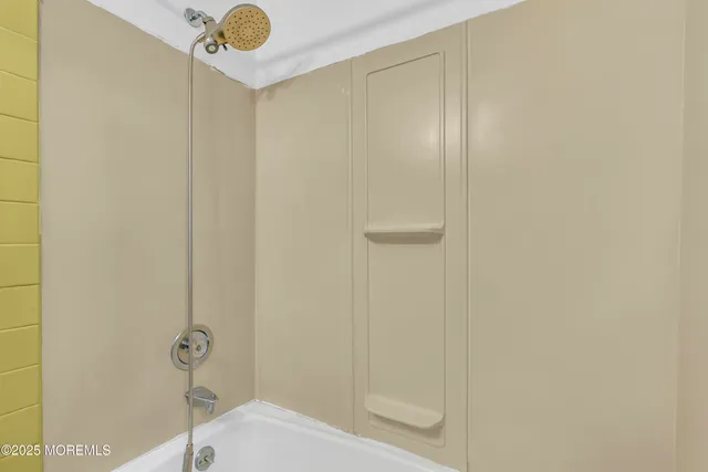 a view of a kitchen with a sink and a refrigerator