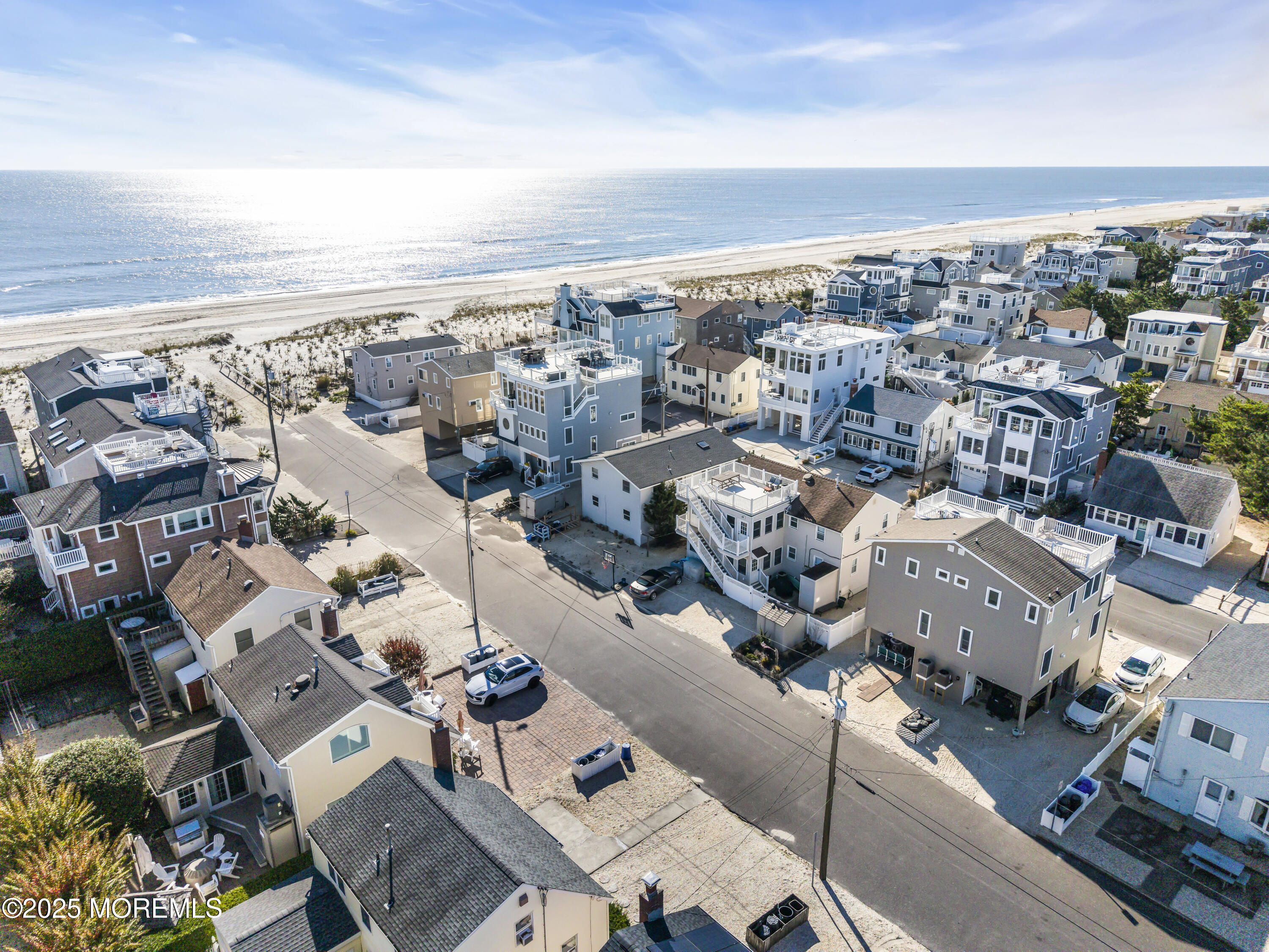 113 East Mermaid Lane Beach Haven, NJ 08008 - Photo 6 of 34 an aerial view of a city with lots of residential buildings and ocean view in back