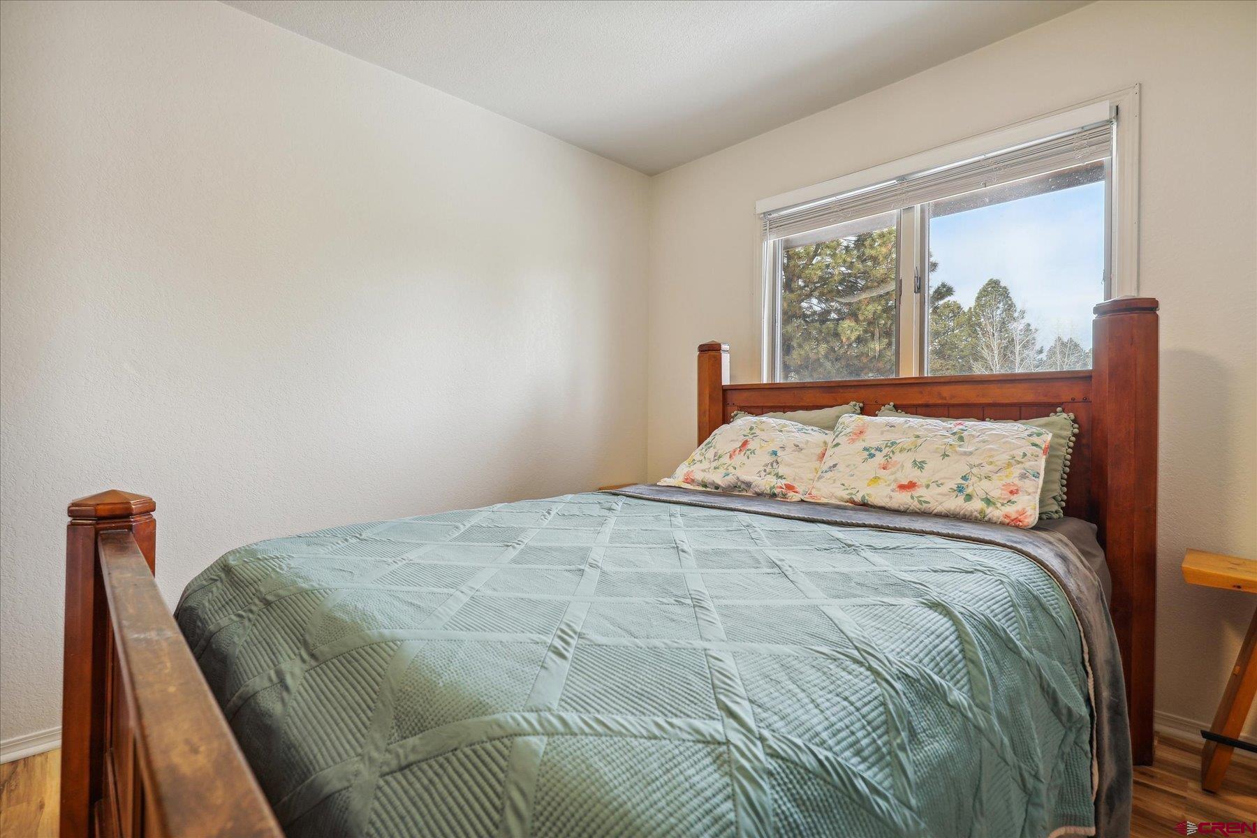 202 Pine Ridge Loop Durango, CO 81301 - Photo 15 of 33 a large bed sitting in a bedroom next to a window