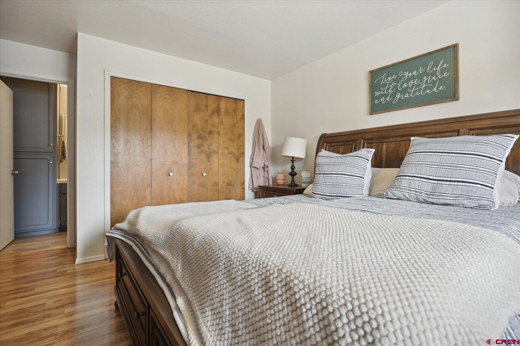 202 Pine Ridge Loop Durango, CO 81301 - Photo 17 of 33 a bedroom with a bed and wooden floor
