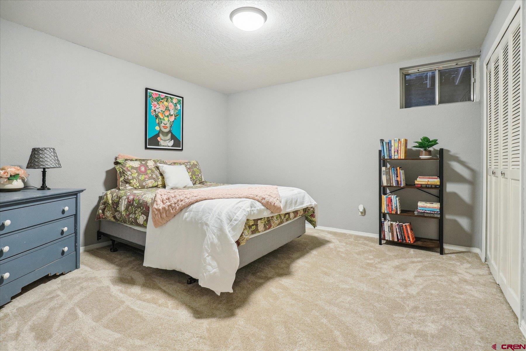 202 Pine Ridge Loop Durango, CO 81301 - Photo 23 of 33 a bedroom with a bed and a cabinets