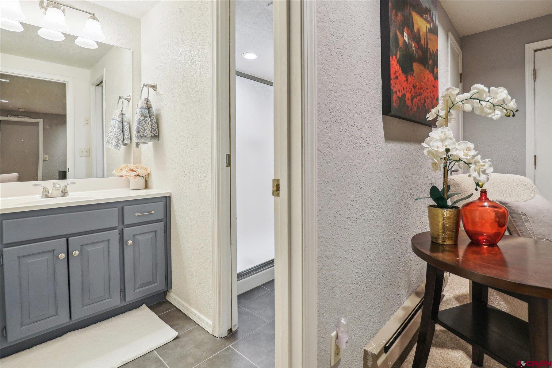 202 Pine Ridge Loop Durango, CO 81301 - Photo 24 of 33 a bathroom with a sink vanity and a mirror